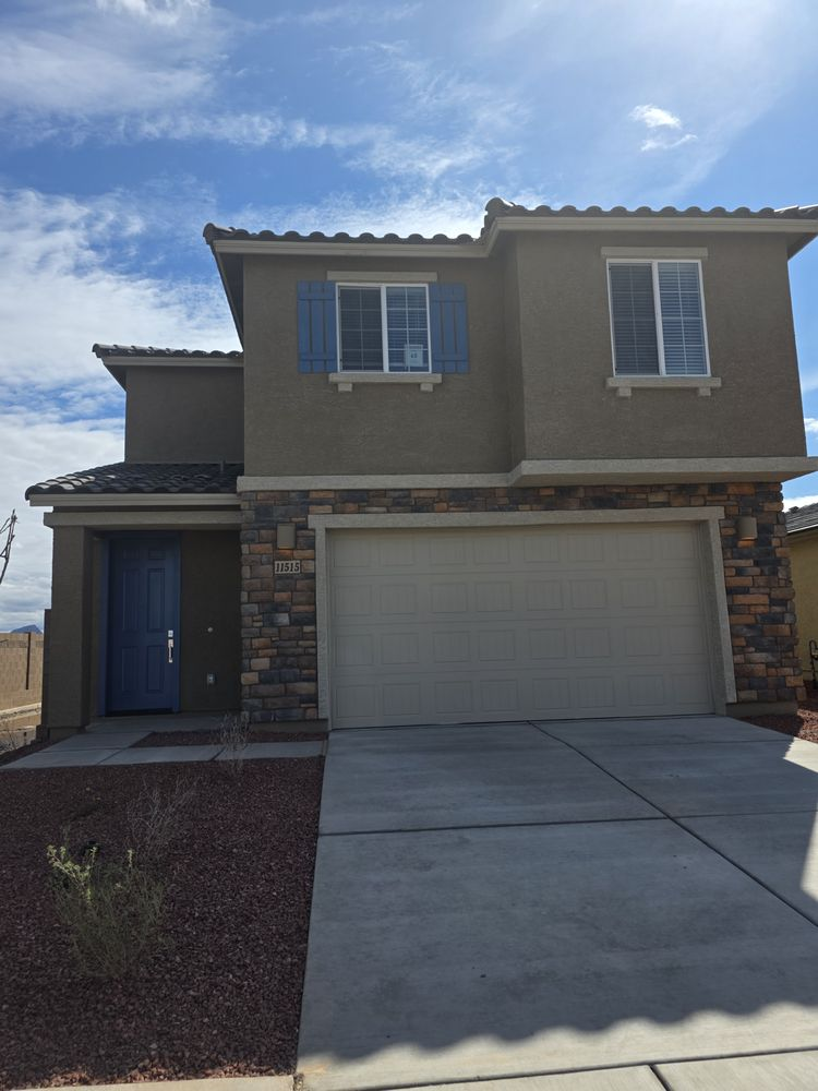 Two-tone stucco exterior with blue door accent